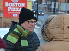 Ontario Green Party leader Mike Schreiner listens to a participant of a rally on the Gitche Namewikwedong Bridge on 10th Street in Owen Sound on Tuesday, January 31, 2023.