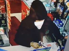 Security camera footage of the robbery suspect, showing their weapon in hand.