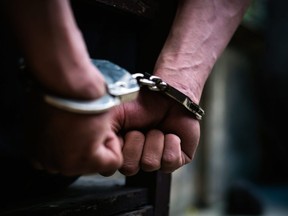 Stock photo of handcuffs placed on wrists