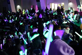 People wave glow sticks in the stands at Shell Place for the opening ceremonies of the Arctic Winter Games on Sunday, January 29, 2023. Vincent McDermott/Fort McMurray Today/Postmedia Network