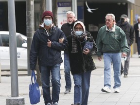 People are seen wearing masks getting off of transit and walking in downtown Toronto. (Jack Boland/Postmedia Network)