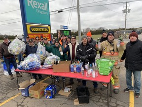 Members of the Waterford Lions Club and Waterford firefighters received thousands of cans and bottles at a bottle drive on Saturday after calling for community help to purchase a stair-lift for Robbie Logan.