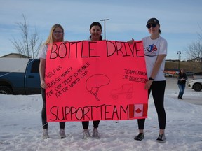 Meira McEllistrum (from left to right), Rylee Stilborn, and April Willie collect bottles on Saturday, January 7 to raise money for their trip to France when they compete with Team Canada for the Junior Roller Derby World Championship.