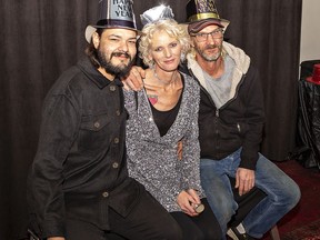 Branden Mudford (left), Lisa Thompson and Allen Mudford get ready to have their picture taken in a free photo booth at the Sanderson Center during the City of Brantford's New Year's Eve celebrations.  Brian Thompson/Brantford Expositor/Postmedia Network