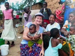 Janice Nyyssonen, of Brantford, with some of the orphans she helped save from a life on the streets of Tanzania during decades-long humanitarian effort.  Mrs.  Nyyssonen died in early December.  Submitted