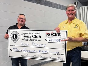 Hagersville Lions Club president Dan Matten (right) presents a check to Rob Davey, the latest winner in the club's Catch the Ace draw. Submitted