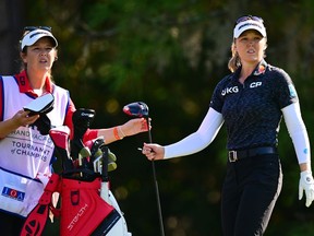 Brooke Henderson hands her driver to her sister and caddy Brittany after playing her shot on the 5th tee during the second round of the Hilton Grand Vacations Tournament of Champions in Florida on Friday, Jan. 20.
Julio Aguilar/Getty Images