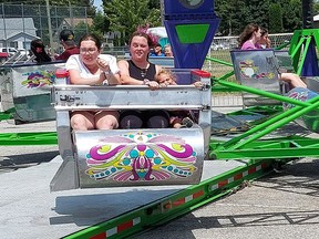 Emily Jones, 21, left, Liddea Bechard, 20, and her two year-old daughter Claire, were hanging on while riding The Scrambler at the Chatham Kinsmen Fair on June 25, 2022. This year's fair has been cancelled after organizers were left in the lurch with no rides. Ellwood Shreve/Postmedia PHOTO Ellwood Shreve/Chatham Daily News
