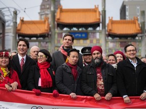Prime Minister Justin Trudeau, second from left, and Conservative leader Pierre Poilievre, at right, should pay attention to the saying: 'It's the economy, stupid.' (Both are seen here at the Lunar New Year parade in Vancouver, Jan. 22.)