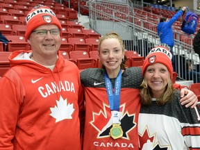 Hannah Tait celebrates alongside her parents in Lake Placid after winning the gold medal game. Handout