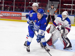 Cornwall Colts goaltender Dax Easter peeks around Navan Grads Devon Savignac as Colts Andrew Langlois gives the Grads player a push on Thursday January 5, 2023 in Cornwall, Ont.