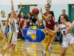 Cobras Amy Schmidtke catapults a pass past Bobcats players at Bow Valley High School in Cochrane on Tuesday, Jan. 10, 2023.