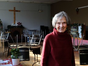 Ann Lyng stands in a common room at St. Mary's Parish Centre on Brock Street in downtown Kingston on Dec. 21, 2022. The space hosts a weekday drop-in centre, and beginning on Jan. 9 is offering 12 overnight beds.