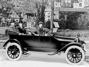John and Horace Dodge ride in the back of their first production model, circa 1914.