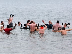 Cold water swimmers sing along to Queen's Bohemian Rhapsody while doing five minutes immersed in chilly water. The group, Wim Hof Kingston, gathered at Richardson Beach in Kingston for their bi-weekly swim on Jan. 8, 2023.