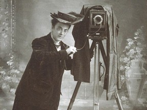 Photographer Jessie Tarbox Beals stands next to her camera (on tripod), with camera trigger in hand, circa 1905. Schlesinger Library, Radcliffe Institute, Harvard University