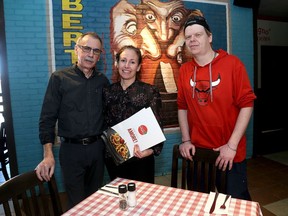 Owner/operators of the Division Street East Side Mario's, Dan Lambert, left, and Lana Saunders, with longtime cook Cory Hollywood at the restaurant on Wednesday.