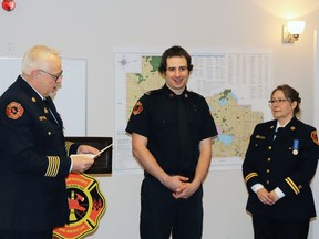 Fire Chief Randy Schroeder, left, had just promoted Lieutenant Blayne Van Kleek as Captain Angela Schroeder observed her at her promotion ceremony last Monday.