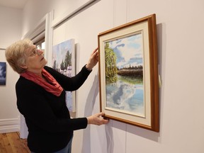 Rennie Janssen, a member of the installation committee with the Lawrence House Centre for the Arts in Sarnia, adjusts an entry to the Floyd Gibson Members' Show. It opens Friday evening and runs through Jan. 27.