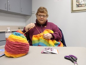 Stacey Clark knits during Saturday's open house at Sarnia's Strangway Center where the city's winter adult recreation programs were showcased.  Clark takes part in a book club and a Knit and Chat program at the centre.  Paul Morden/The Observer