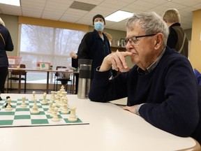 Gerry Rogers ponders a move on a chess board during Saturday's open house at Sarnia's Strangway Center where the city's winter adult recreation programs were showcased.  Paul Morden/The Observer