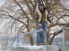 A construction worker checks armor stone Wednesday for a shoreline protection project underway along the Lake Huron shoreline in Sarnia's Bright's Grove.
