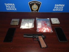 Sarnia police released this photo of cocaine and a replica handgun found during a search of a home in the city.