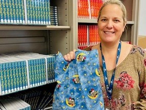 Melissa Doan, a maternal infant child nurse at Bluewater Health, holds a Baby Bookworm bag.