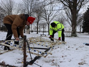 Shane Mestancik, left, and Dean Holtz take down a display Saturday at the Celebration of Lights in Sarnia's Centennial Park.