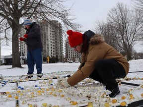 Paul Belander, left, and Shane Mestancik take down a display at the Celebration of Lights in Sarnia's Centennial Park.