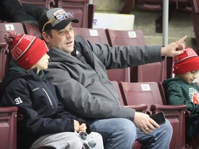 Matt Stark talks with his son Caiden Stark, a member of an U11 AA team from North Toronto, Saturday while watching a game during the Silver Stick tournament at the Progressive Auto Sales Arena in Sarnia.