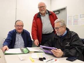 John Mellor, center, who was overseeing volunteers at the North American Silver Stick U11 and U18 finals hockey tournament in Sarnia on the weekend, is shown with volunteer marshals John Desotti, left, and Paul Douglass at the Progressive Auto Sales Arena.