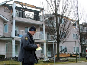 Mike Bird, an investigator with the Ontario Fire Marshal's office, makes notes on Jan.  16 while standing near Fairwinds Lodge retirement home, which was heavily damaged by a fire two days earlier.  (Terry Bridge/Sarnia Observer)