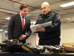 Public Safety Minister Marco Mendicino, left, looks over drug and weapon seizure information Jan.  17, 2023 with Rob Wilson, acting director at the Blue Water Bridge of Canada Border Services Agency staff.  Mendicino was visiting the border crossing as part of a tour promoting federal investments in more CBSA personnel and tech.  (Tyler Kula/ The Observer)