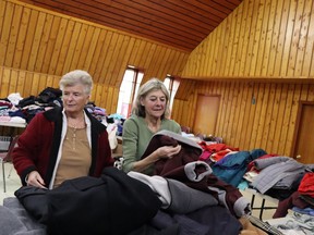 Volunteers Pam Simpson, left, and Beth Greaves sort donations at Community of Christ Church, 1104 Leckie Dr., in Sarnia.  Donations of clothing and personal care items for residents displaced by the fire at Fairwinds Lodge will be accepted at the church, 9 am to 6 pm, all this week.  (Paul Morden/Sarnia Observer)
