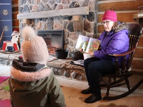 Ellen Dark, a community librarian with the Lambton County Library, leads story time Friday in the log cabin at the Children's Animal Farm in Sarnia during Stories on the Farm, a Family Literacy Day event.