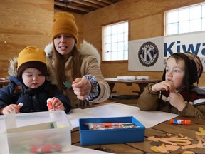 Kaitlyn Timmermans and her sons Ishmael, 1, and Kiyan, 3, make crafts Friday in the Carriage House at the Children's Animal Farm in Sarnia during Stories on the Farm, a Family Literacy Day event.