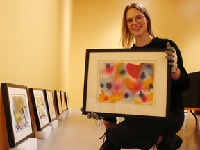 Sonya Blazek with the Judith and Norman Alix Art Gallery in Sarnia poses with works by William Ronald being featured in the second exhibition in the gallery's Re View series. The exhibition runs Feb. 3-April 15. (Tyler Kula/ The Observer)