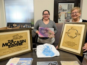 Carolyn King, right, former chief of Mississaugas of the Credit First Nation, leads the Moccasin Identifier program, which uses stencils of Indigenous moccasins to teach schoolchildren about First Nations treaties and culture. Tamara Cochrane, the projects cultural awareness coordinator, holds one of four stencils included in education packages distributed to schools.
