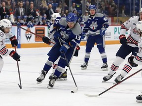 Kocha Delic, middle, of the Sudbury Wolves, attempts to break between Oshawa Generals defenders during OHL action at the Sudbury Community Arena in Sudbury, Ont. on Friday January 6, 2023.