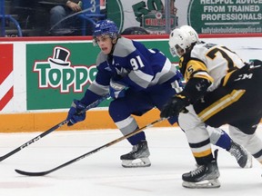 Evan Konyen, left, of the Sudbury Wolves, attempts to skate past Jorian Donovan, of the Hamilton Bulldogs, during OHL action at the Sudbury Community Arena in Sudbury, Ont. on Friday January 20, 2023. John Lappa/Sudbury Star/Postmedia Network
