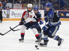 Nathan Villeneuve, right, of the Sudbury Wolves, attempts to skate past Nick Graniero, of the Windsor Spitfires, during OHL action at the Sudbury Community Arena in Sudbury, Ont. on Friday January 27, 2023. John Lappa/Sudbury Star/Postmedia Network