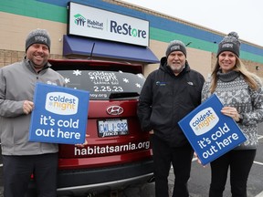 From left, Trevor Taylor, David Waters and Angela Kirkland, with Habitat for Humanity Sarnia-Lambton, wear toques like the ones available for fundraisers taking part in this year's Coldest Night of the Year walk Feb. 25. Paul Morden/Postmedia