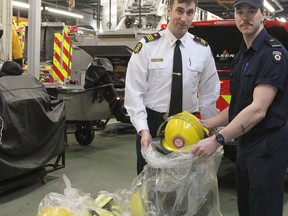 Scott Foster, left, acting chief training officer for the Timmins Fire Department, and Timmins firefighter Devon Lauzon were filling some of the bags of expired firefighting equipment on Thursday that is being shipped to the Ukraine so it can be used by that country's emergency services.

RON GRECH/The Daily Press