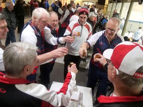 After 'stacking the brooms' in Simcoe on Tuesday, Jan. 17, Scottish and Canadian curlers enjoyed a dram of whisky, an old Scottish curling tradition. Clockwise from bottom left are Mike Davis, John Stevenson, Willie Paterson, Iain Buchanan, Derek Sutton, Alastair Fyfe, Mike Cobb and Rob Inglis.