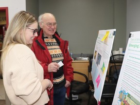 Development Officer Samantha Kemp spoke with residents like Henry Lee at the open house at the Allan and Jean Millar Centre on Tuesday night. The session covered future land use planning in town, for homes and businesses.