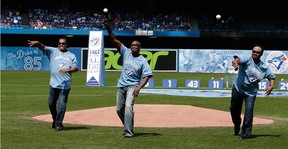 Former Toronto Blue Jays George Bell, Lloyd Moseby and Jessie Barfield throw the ceremonial first pitch against the New York Yankees in Toronto, Ontario.  on Sunday August 16, 2015. (Craig Robertson/Postmedia Network)