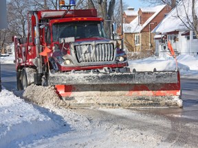 A City of Sarnia snowplow operator scrapes snow to the side of Exmouth Street on Wednesday, Jan. 8, 2014. (File photo)