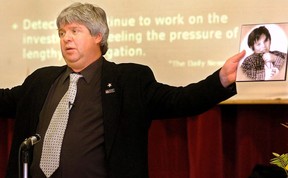 Mike Neuts holds up a picture of his son Myles during an anti-bullying workshop at St. Roberts school in London in 2006. (File photo)