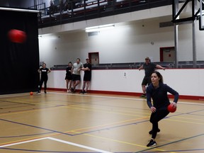 Michelle Hiemstra looked to dodge a ball while preparing to lob one of her own during the Dodgeball Showdown, held at the Allan and Jean Millar Centre Friday night. The town hosted the annual dodgeball games for adults, complete with music and bar service. This is the third year Whitecourt has had the Dodgeball Showdown, said Recreation Co-ordinator Emma Harper.